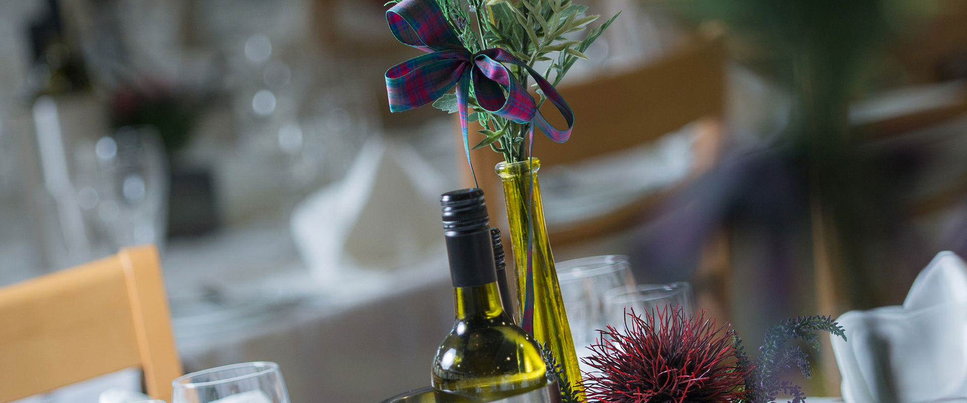 Table setting at EH15 restaurant, with flowers, wine glasses and a bottle of wine.