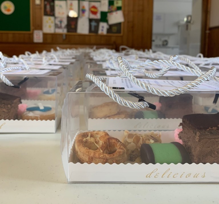 Selection of cakes and bakes boxed up on a table at Liberton Church.