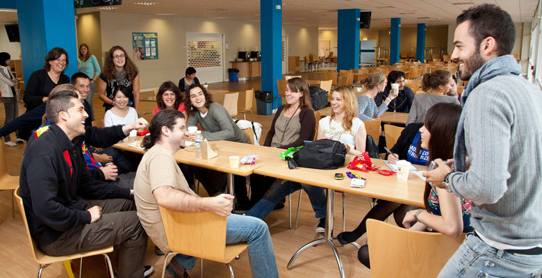 Group of students enjoying their lunch break in a canteen.