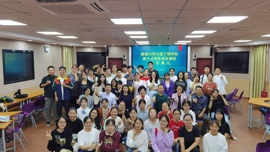 A diverse group of students pose together in a classroom, celebrating the start of a new business English course.