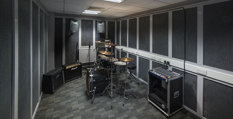 Drum kit and amps in a recording studio at Edinburgh College.