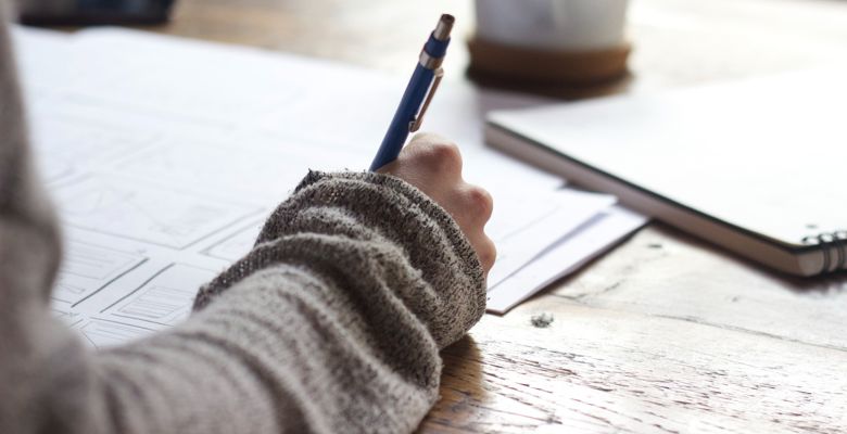 Close up of writing notes at a desk.