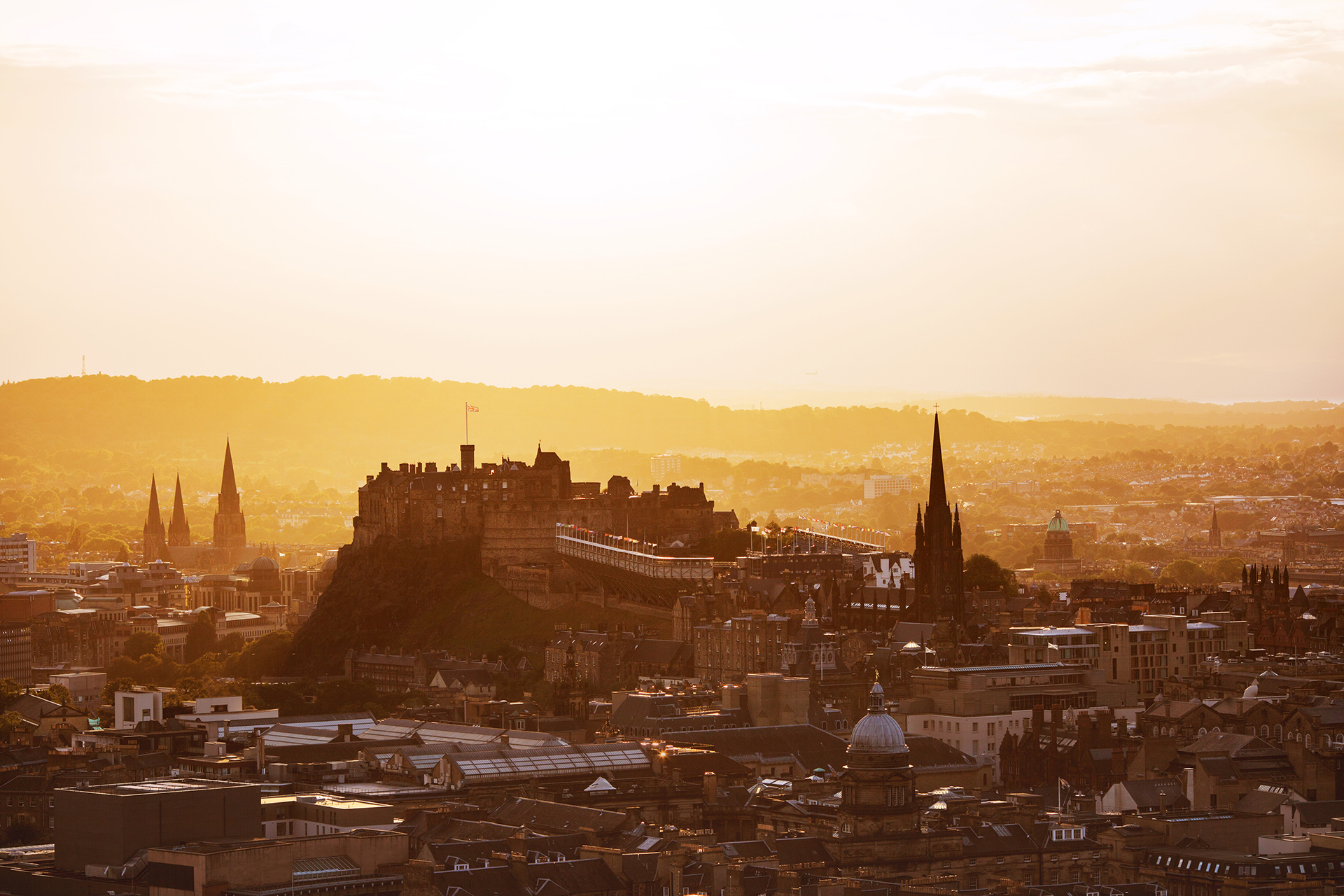Edinburgh skyline with an orange sky at sunset.