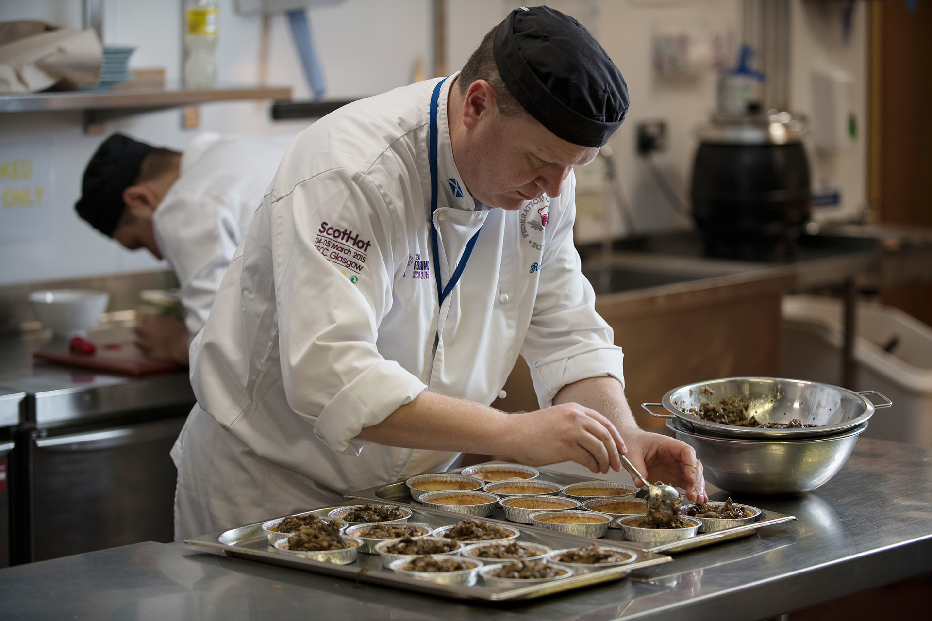 Cookery student preparing dishes in a training kitchen.