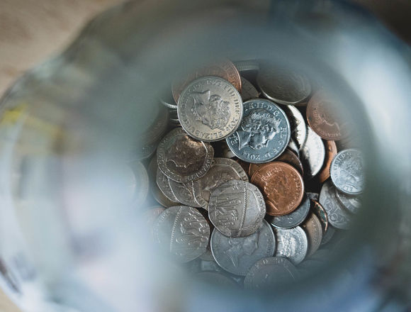Pot of money with coins at the bottom.