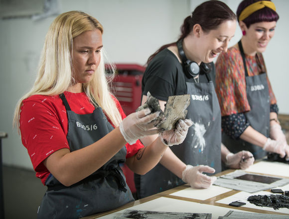Art students working on a project in an art studio classroom.