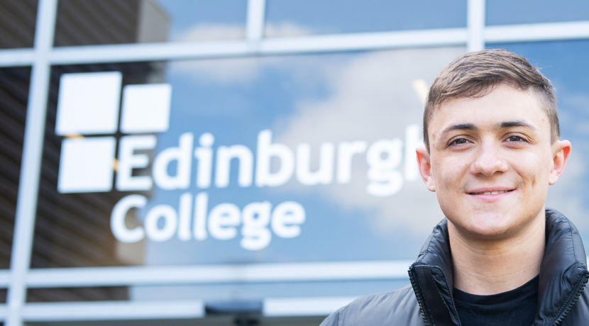 Young student standing outside a campus building.
