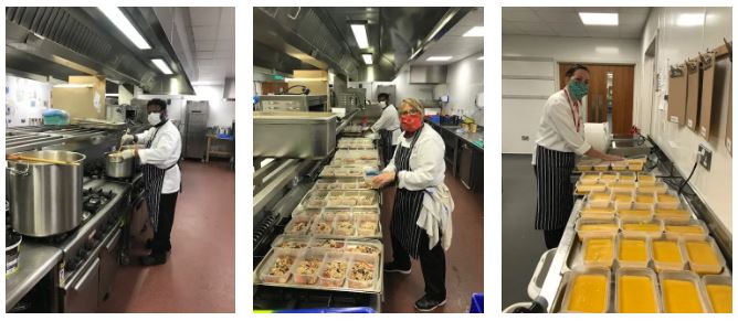 Three cookery students are preparing meals in a kitchen.