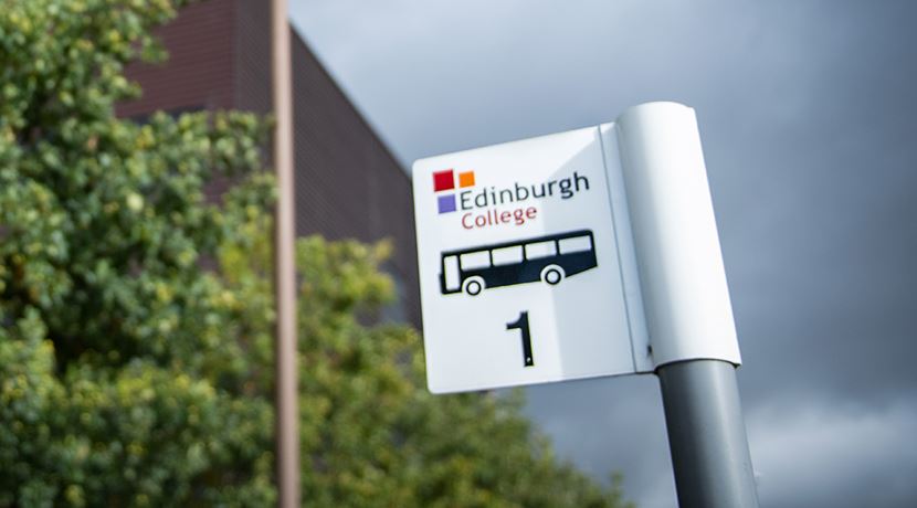 Bus stop sign outside Midlothian campus building.
